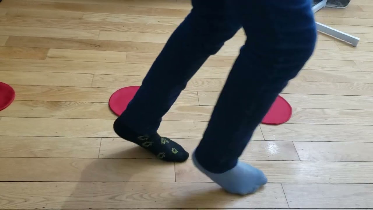 A girl training with ASZORTID Target Shots or Mini Discs in a walking backward & around drill motion