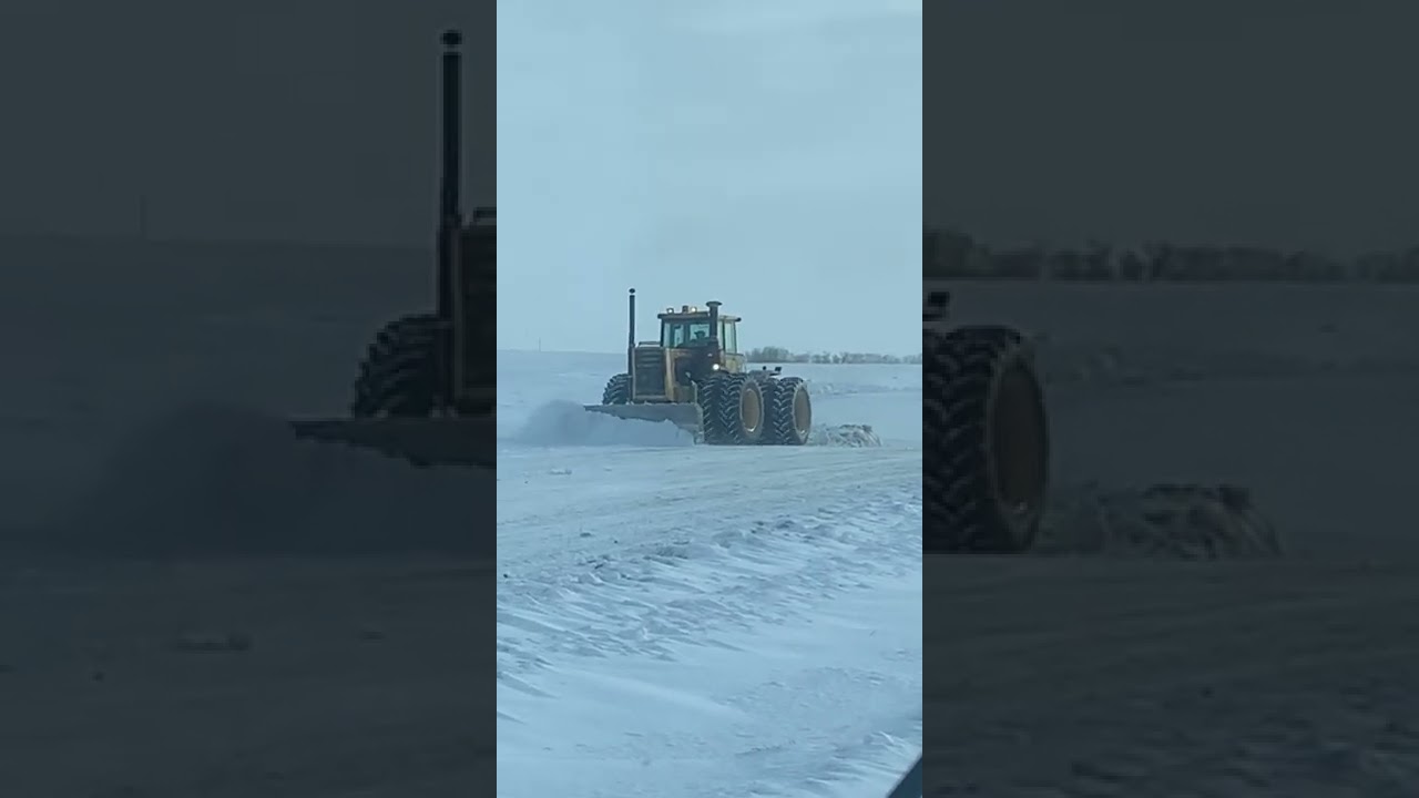 Large tractor plowing snow