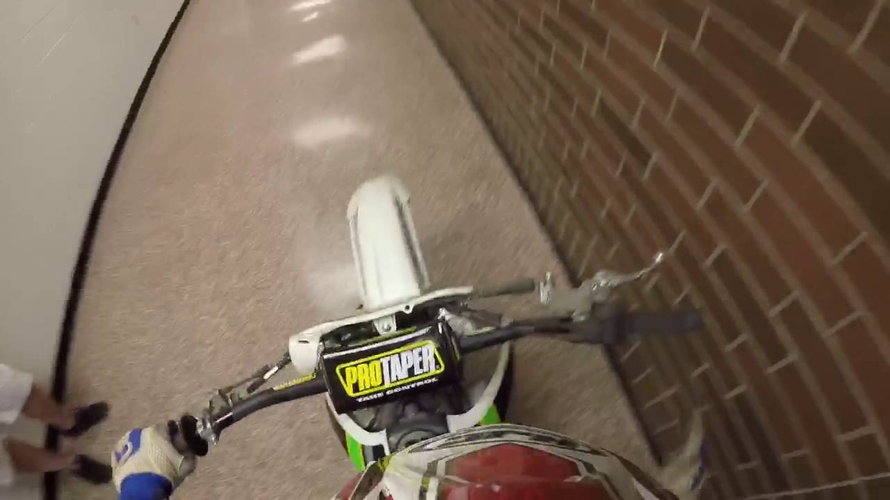 Riding dirt bike through school