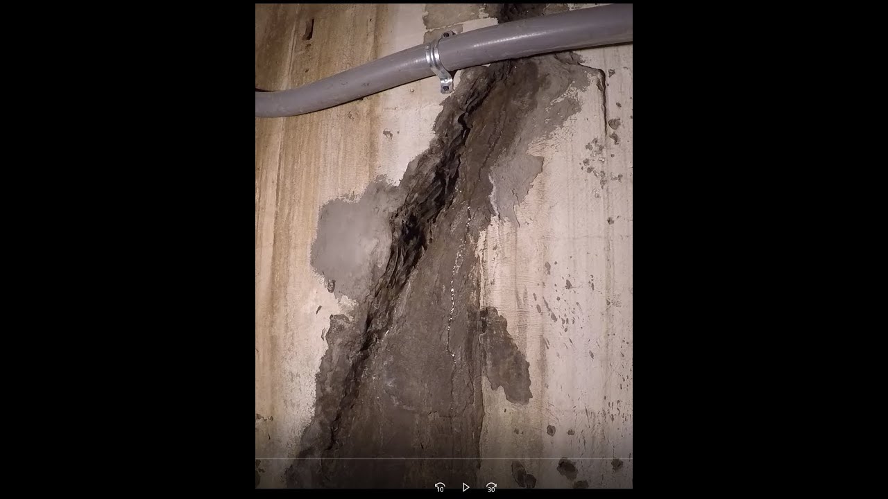Waterproofing basement wall crack and leak with hydraulic cement.