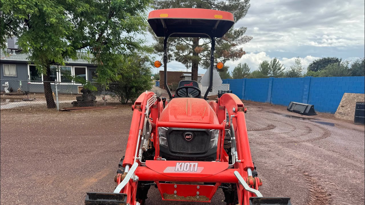 Kioti Tractor, women can do it all, rainy day work!