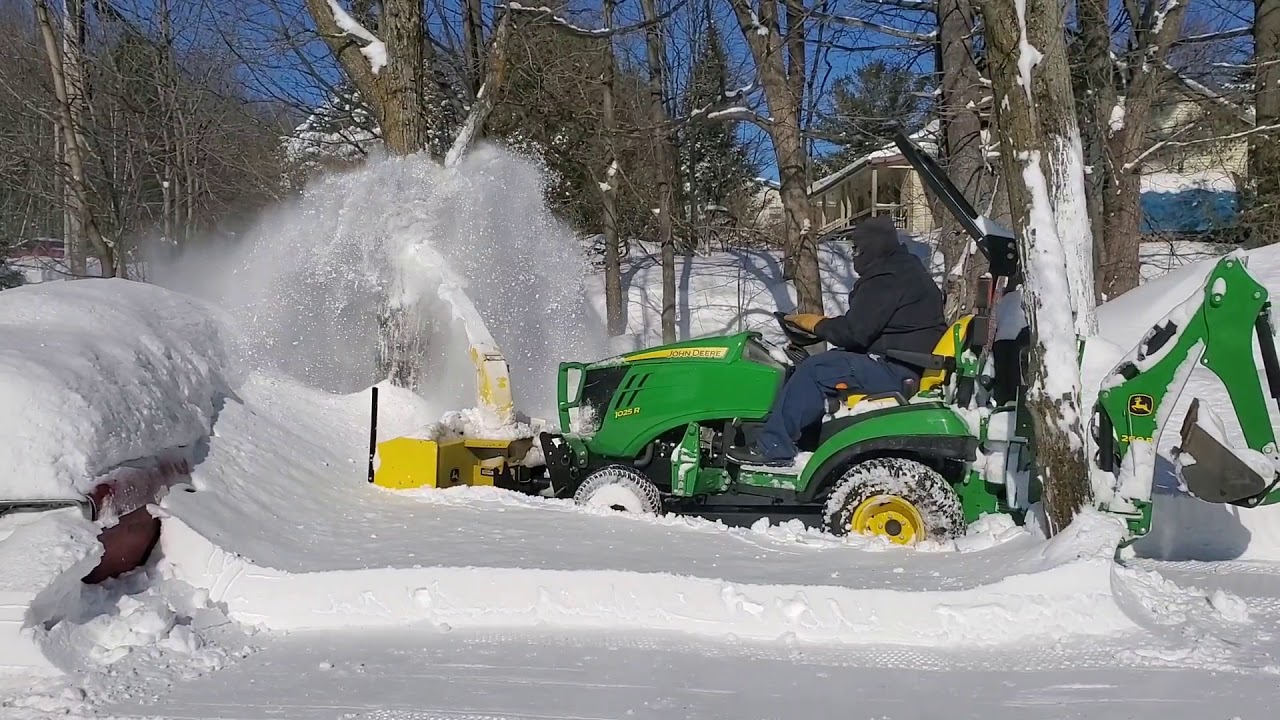 John Deere 1025r with front snow blower in 12inch of snow.