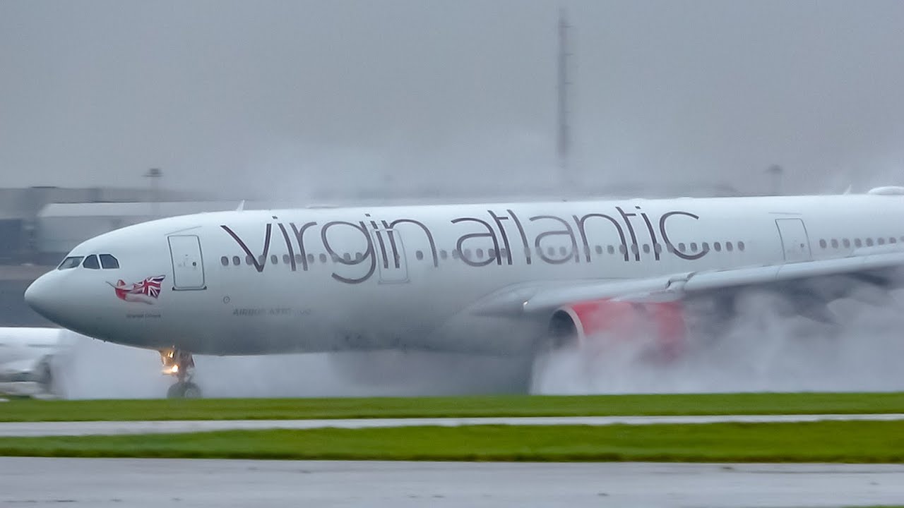 Planes Landing on a Wet Runway at Manchester Airport