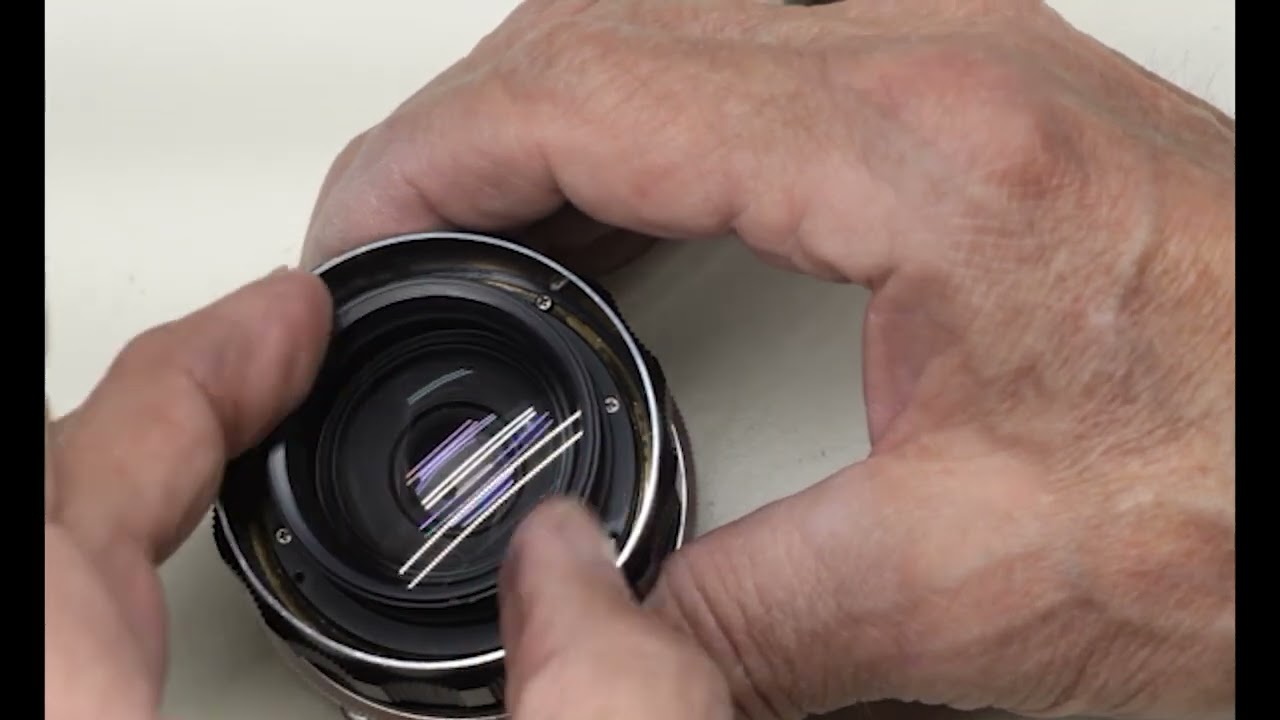 Minolta MC W.Rokkor - HG 35mm 2 8 installing the aperture blade housing into the lens barrel.