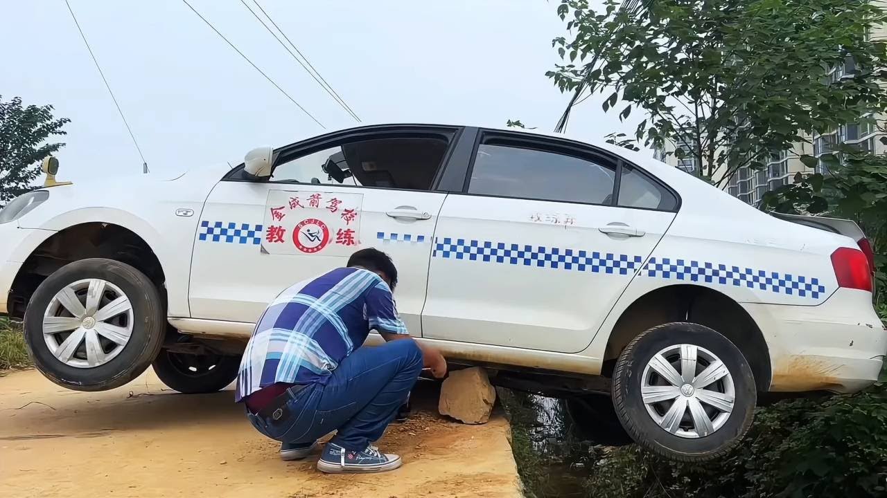 Both Rear Wheels Of My Car Have Fallen Off The Curb. How Can I Get Myself Out?