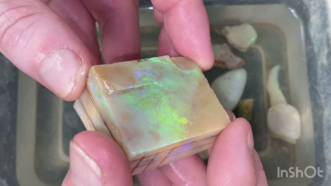 Opal cutting: Andamooka matrix opal: reds and purples.