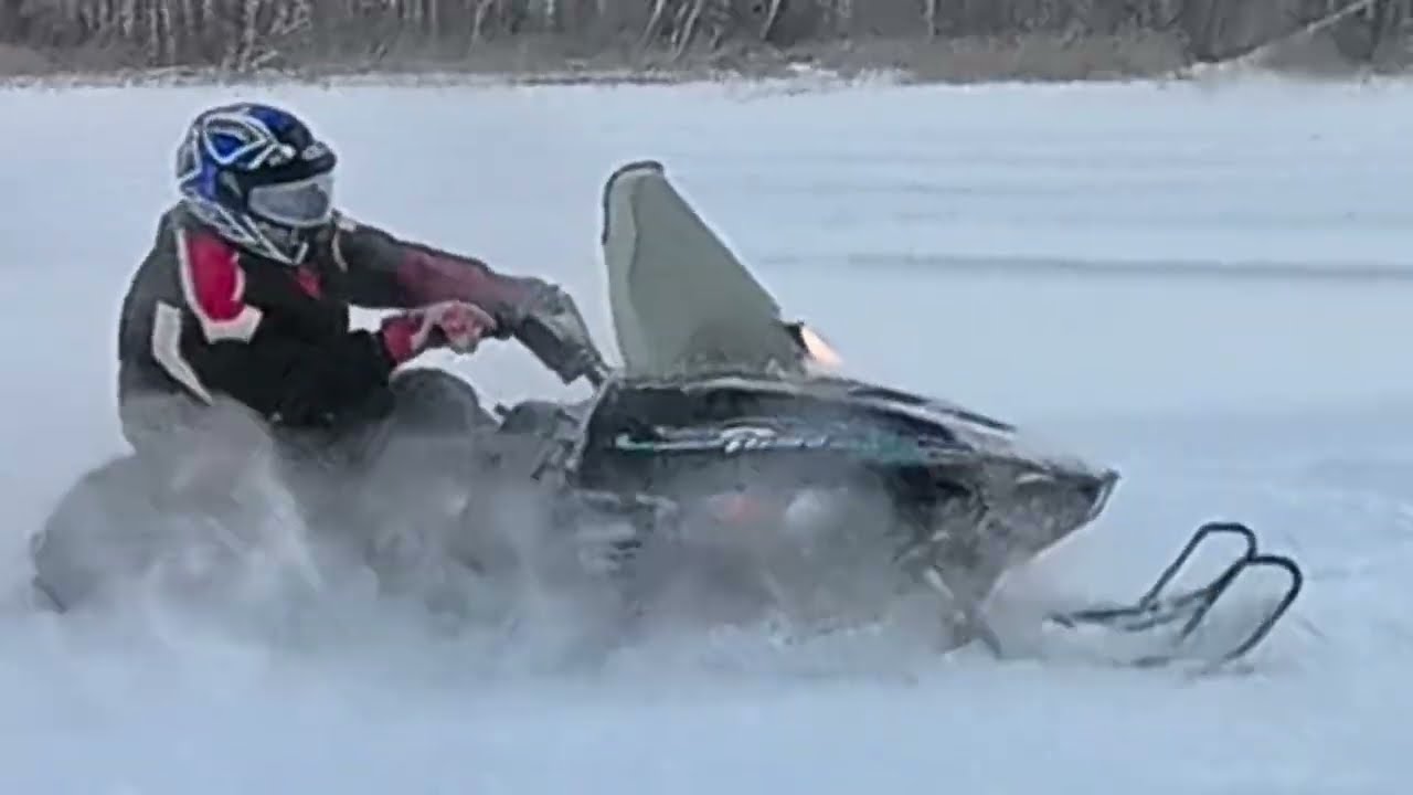 30 year old Arctic Cat Puma playing in the snow with two 50 year old John Deere snowmobiles 
