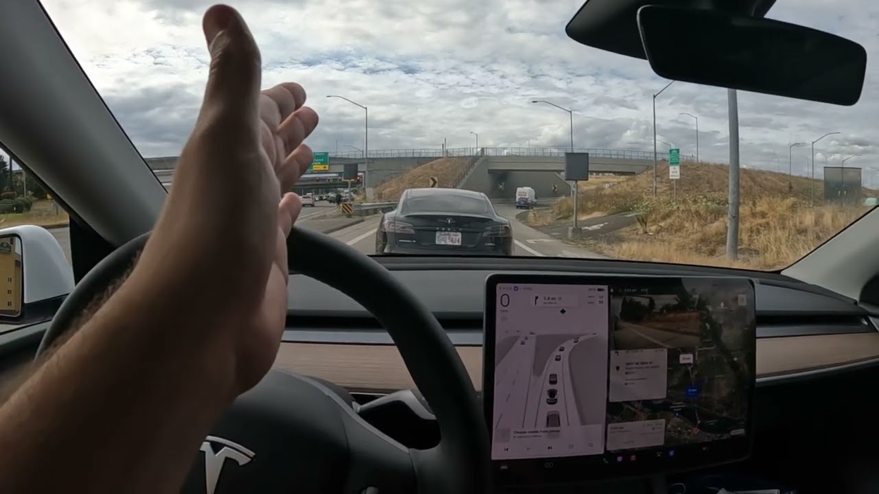 Tesla FSD handles freeway merge in traffic like a pro.