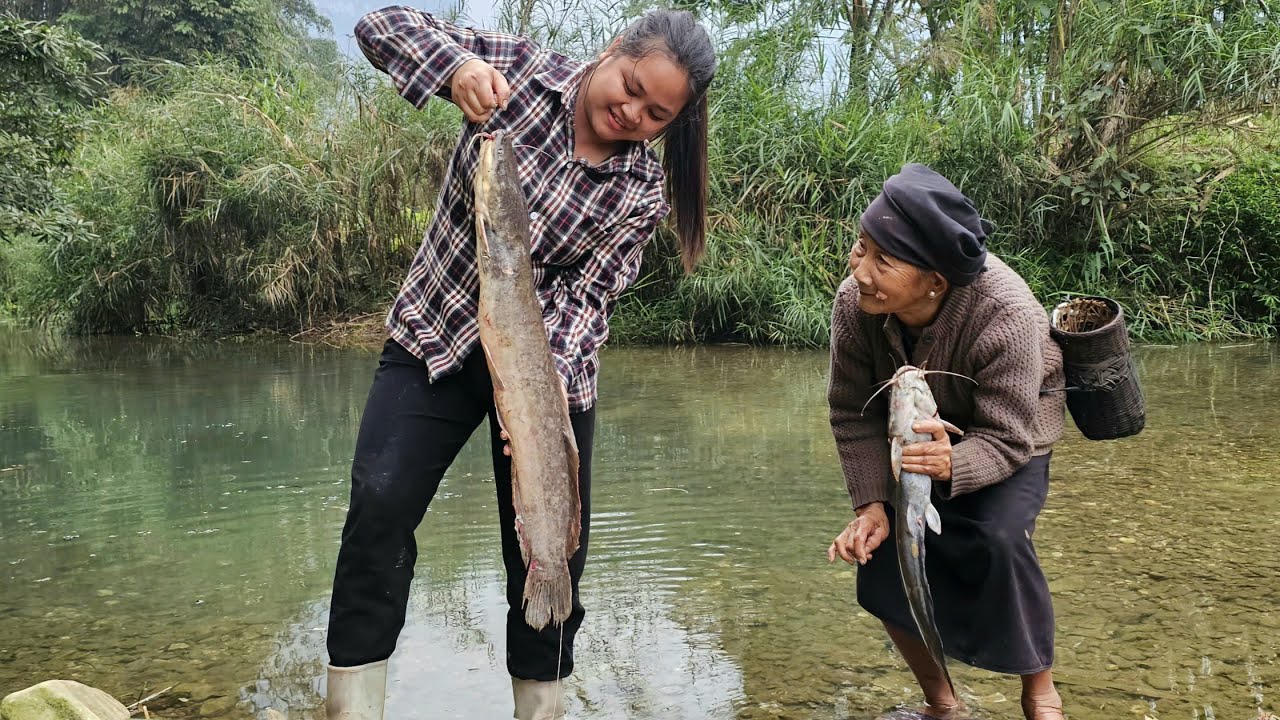 The old woman and her granddaughter were overjoyed when they caught a large fish in the river.