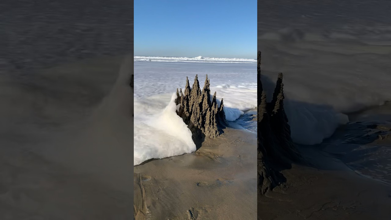 Sandcastle destroyed by a wave