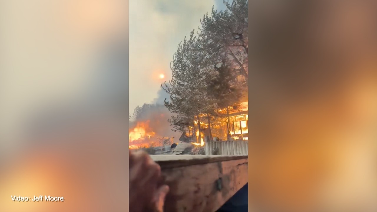 RAW: Man flees into Okanagan Lake as cabin burns
