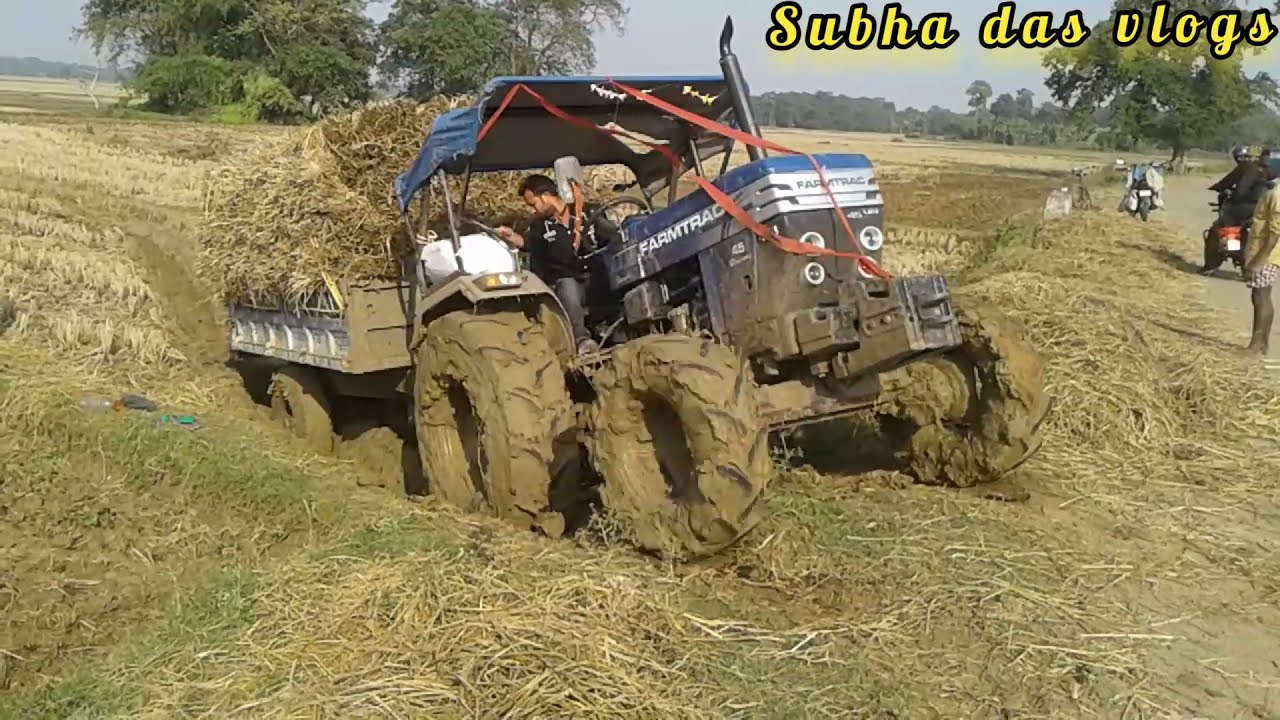 Farmtrac 45 tractor stuck in deep mud with heavy load.