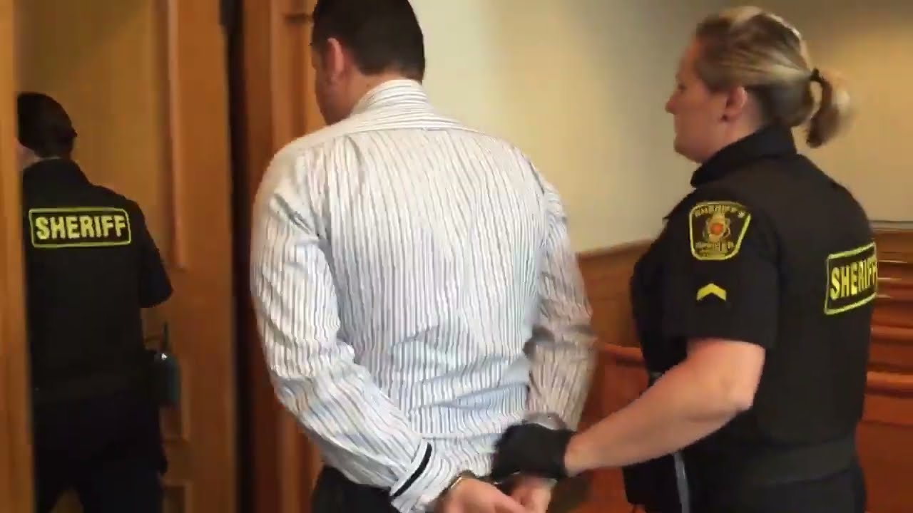 two policewoman escorted a man from court to prison.