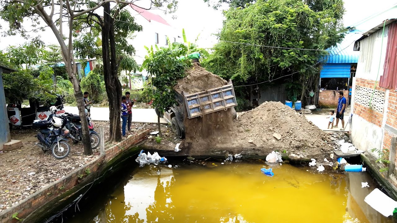 Activities of pouring soil into the site behind the school and dumping garbage by machinery