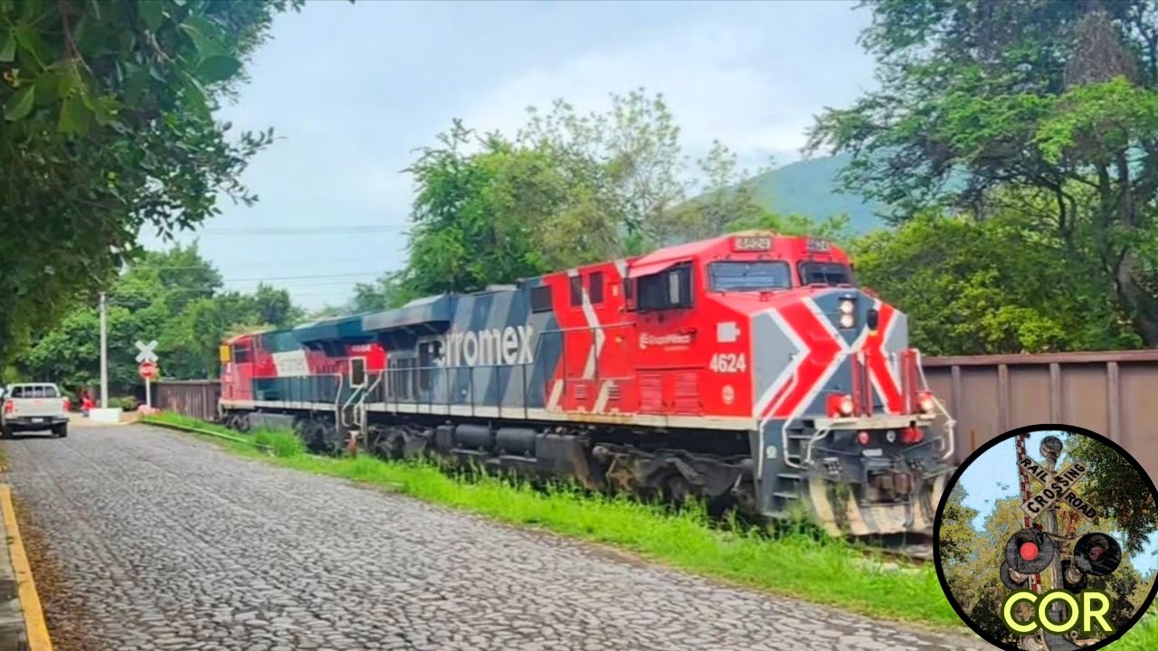 a Ferromex empty freight train flies past by another train in Tuxpan, Jalisco, MX!