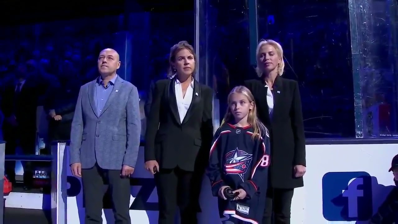 Matiss Kivlenieks family participates in a ceremonial puck drop in his honour
