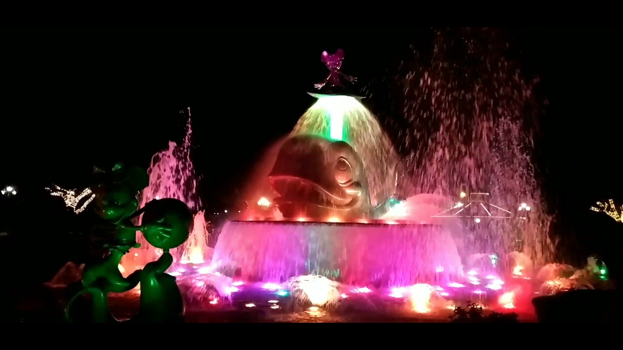 Mickey Mouse on top of dramatic fountain/ Disneyland adventure
