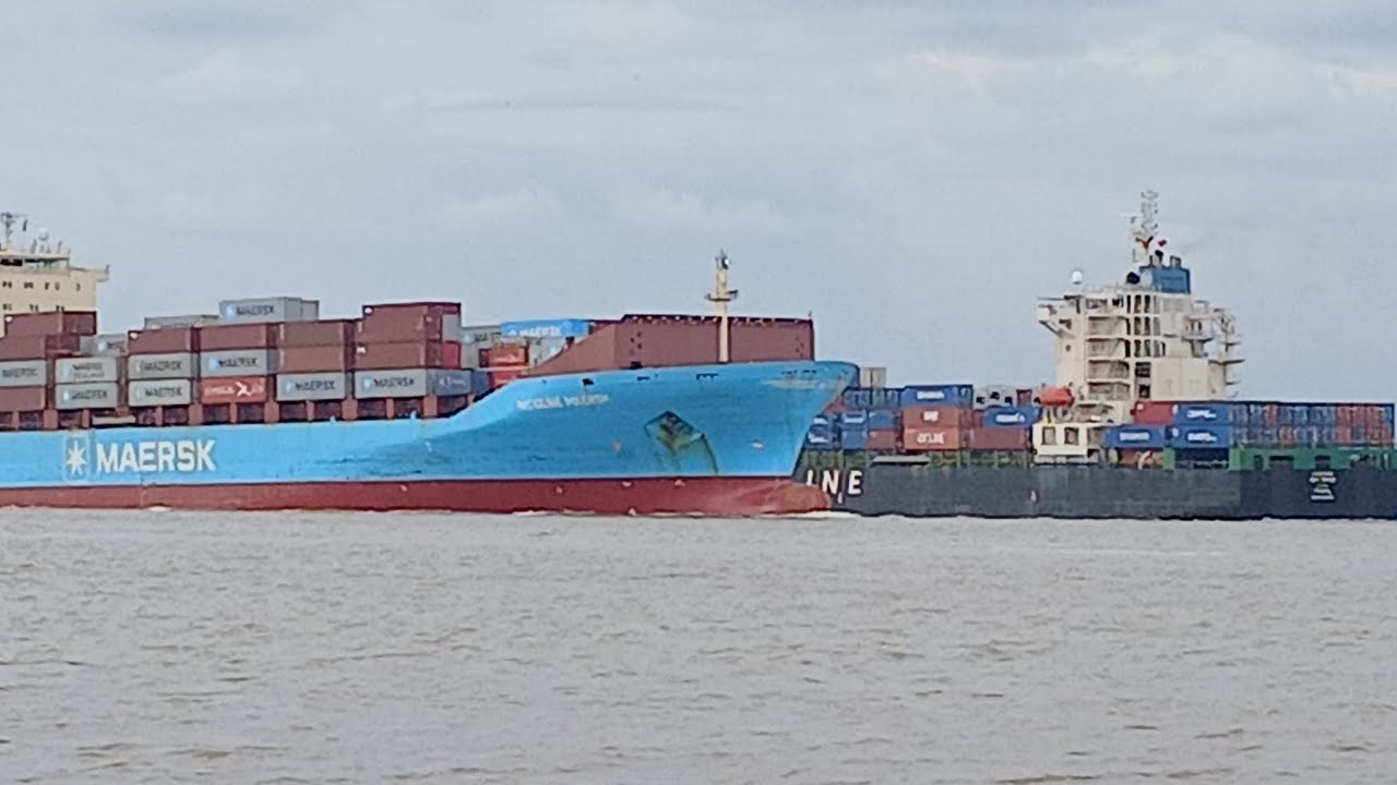 Close-up of two container ships facing each other just meters apart on a narrow river!