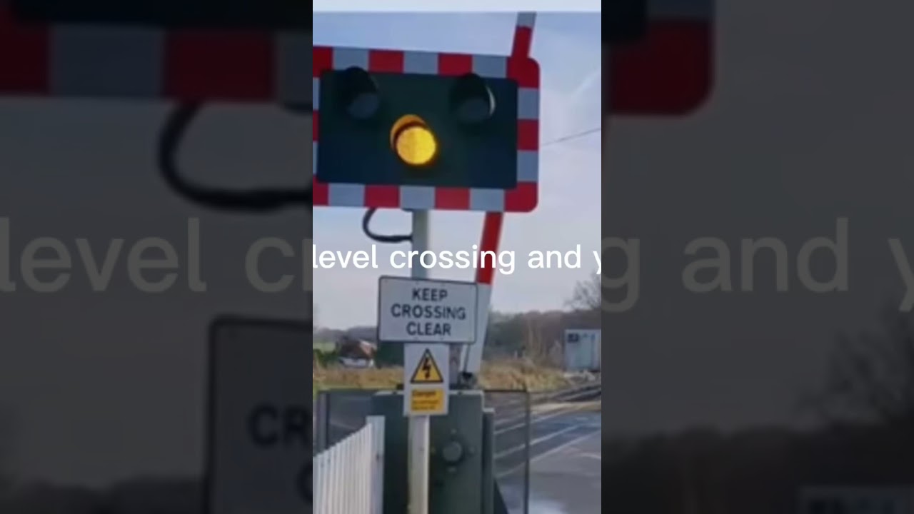 Level crossing/steady amber light/warning sign/train is approaching