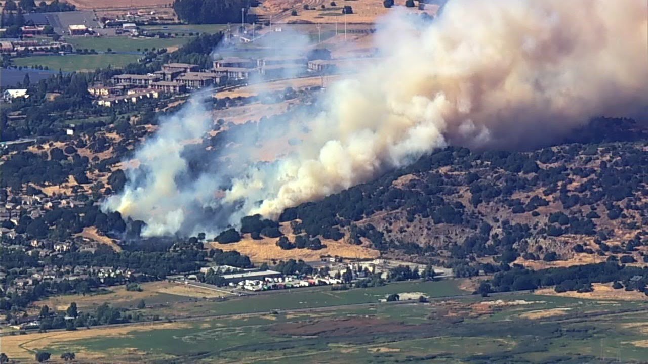 Crews battling brush fire burning near homes in California