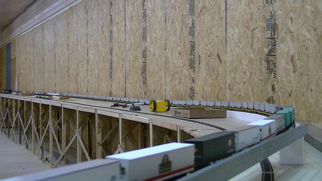 Very long HO scale CSX intermodel climbing up and over same train
