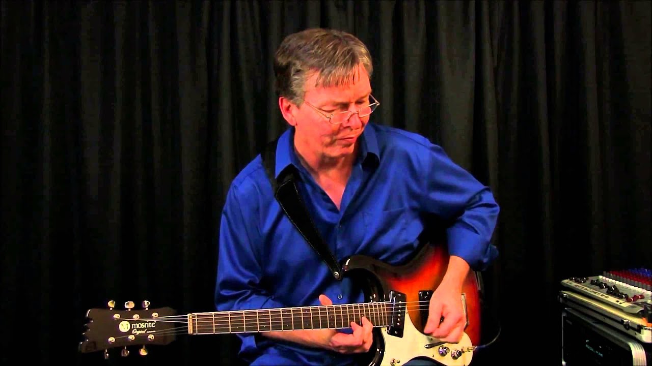 RAVIN BLUE on a Left Handed Mosrite guitar