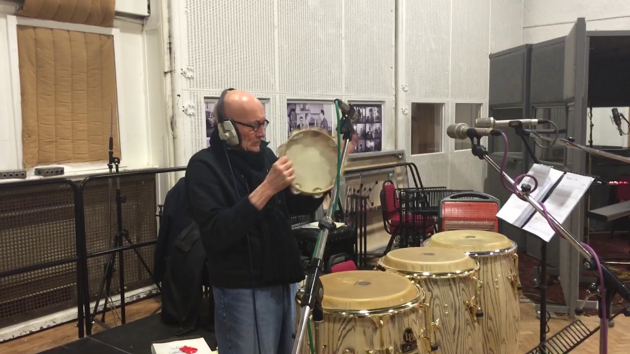 Ray Cooper plays the tambourine.
