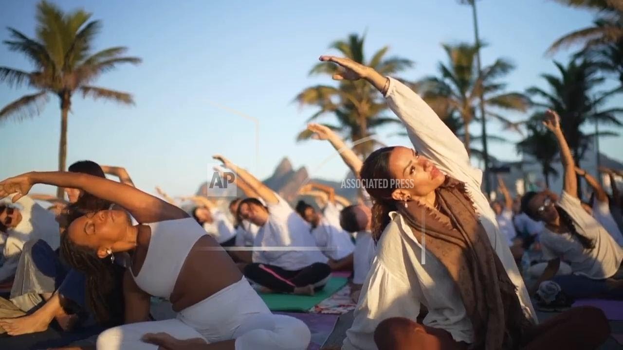 Yoga enthusiasts celebrate International Yoga Day in Rio's beach sunrise