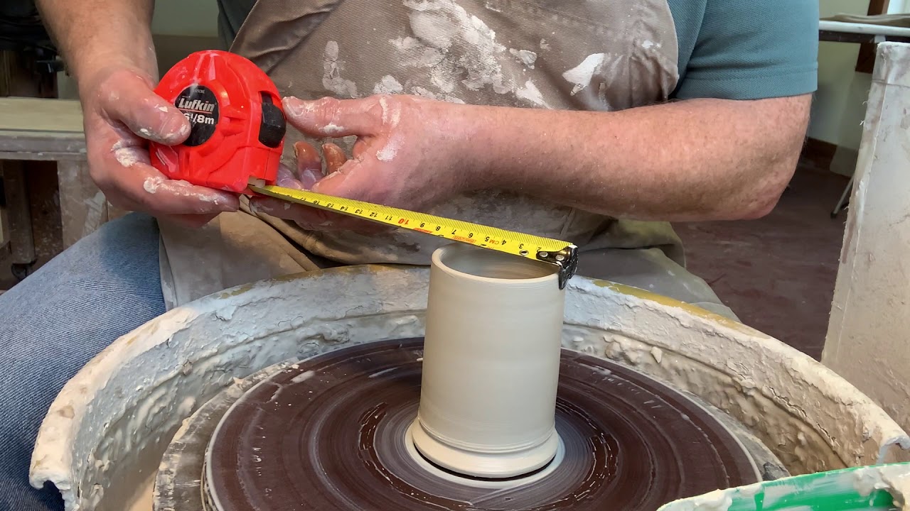 5 thrown coffee mugs, 5 different weights of clay.