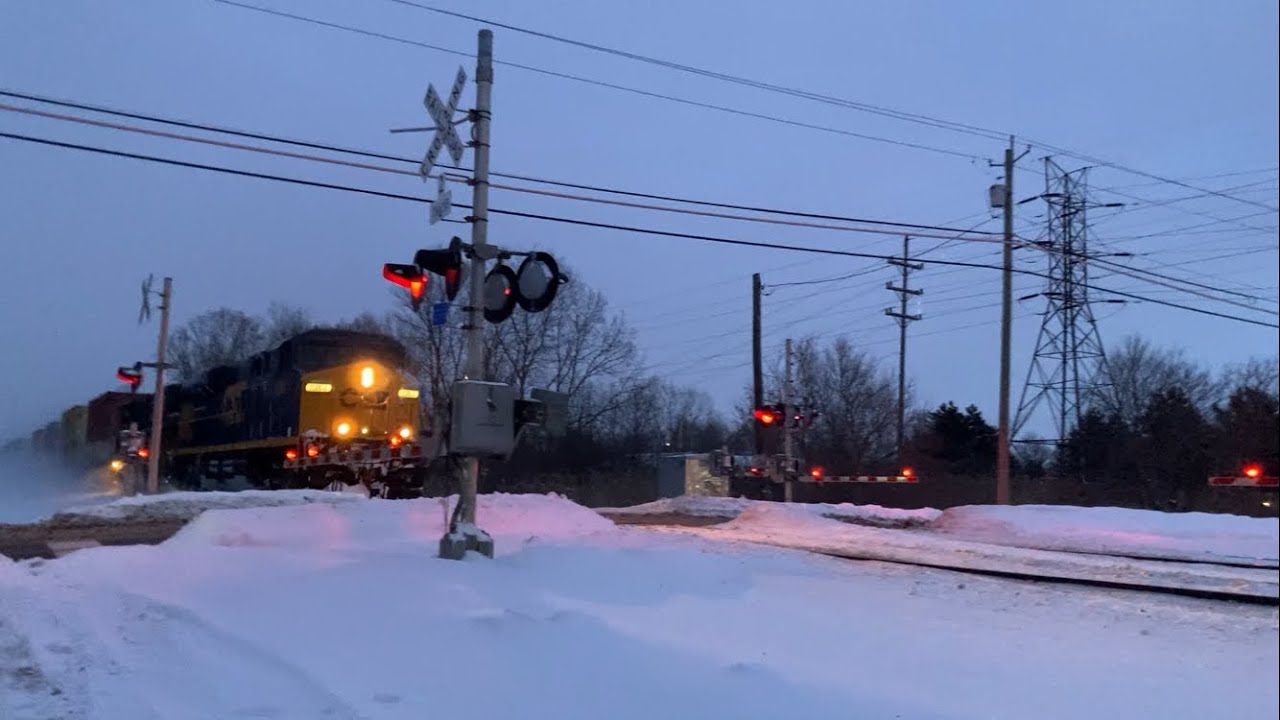 Priority CSX train flies by kicking up snow
