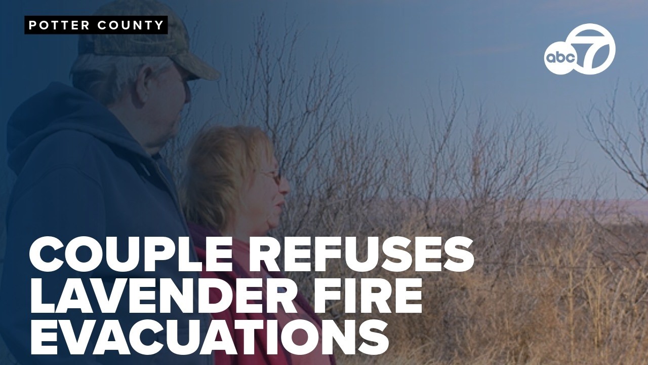 Couple stayed behind with three large dogs as wildfire crossed highway and neared fence