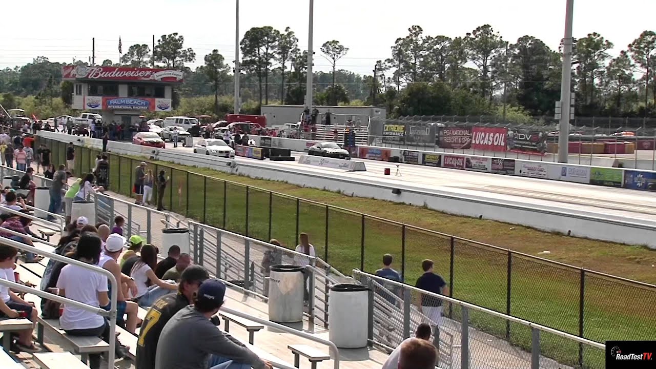 Twin Turbo BMW M5 vs Supercharged Jaguar XKR 1/4 Mile Drag Race - Road Test TV ®