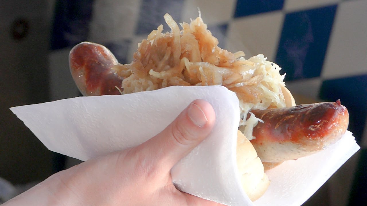 Germany Street Food. Huge Grill of Bratwurst Sausages and Long Skewers