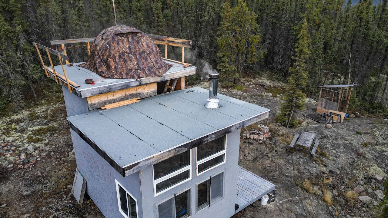 Putting a tent on a cabin