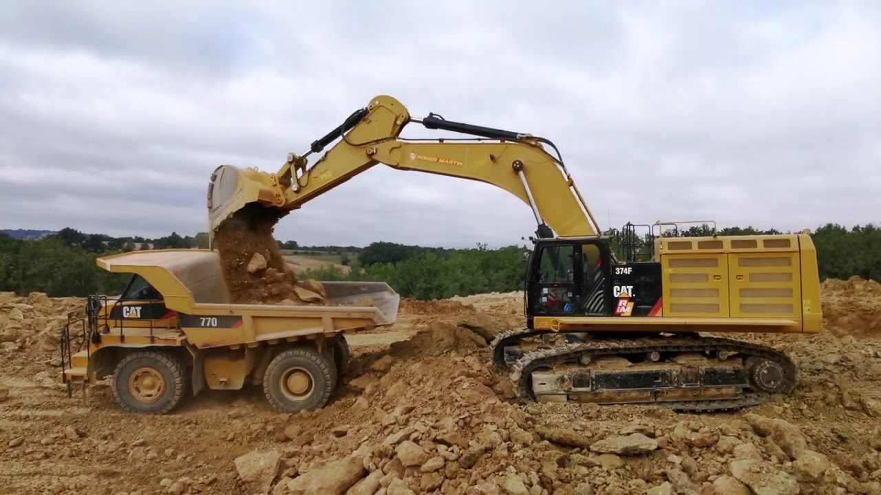 Caterpillar 374F loading 769C, 770 and 740