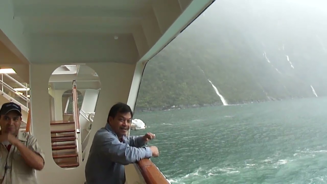 CRUISING FIORLAND NATIONAL PARK NEW ZEALAND TOURIST