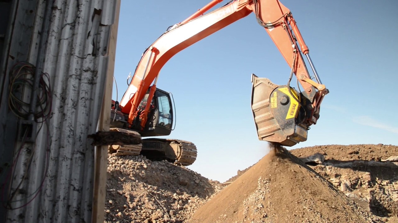 Crushing concrete and limestone in Canada with two MB Crusher buckets