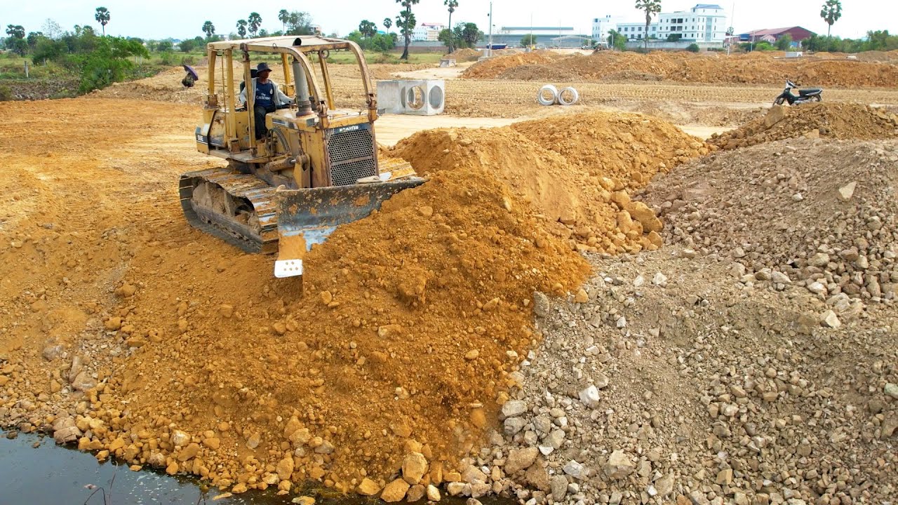 Strongly power Komatsu Bulldozer work hard on huge landfill with terrible dirt for fill
