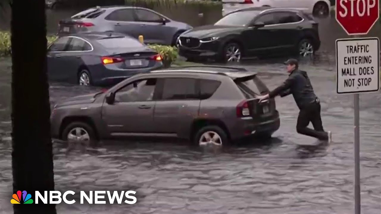 WATCH: NBC reporter pushes car out of water as severe flooding hits South Florida