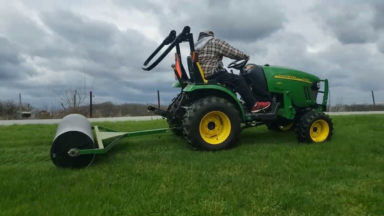 Rolling the yard with the John Deere 2320