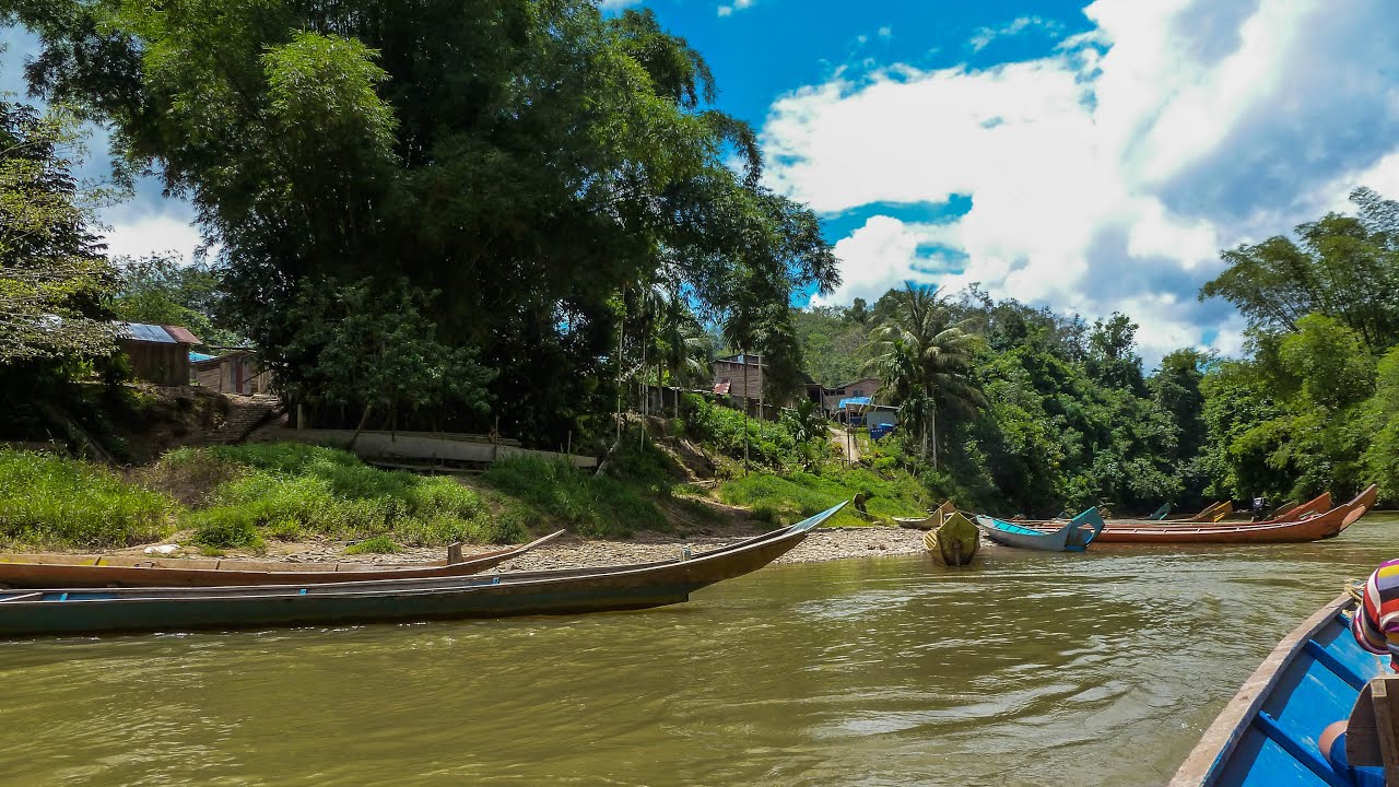 Longboat up the Lemanek river to Iban Longhouse, Borneo