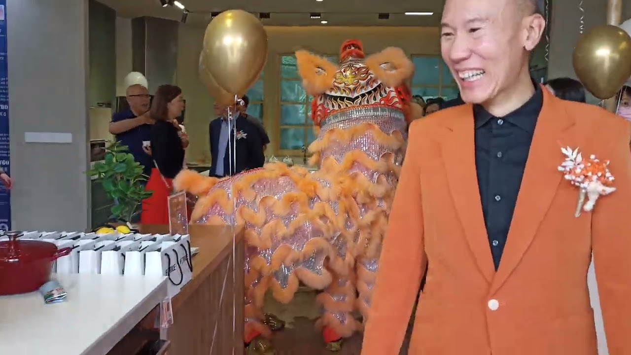 Lion dance with God of Prosperity bringing luck, wealth, and booming business to the electric shop