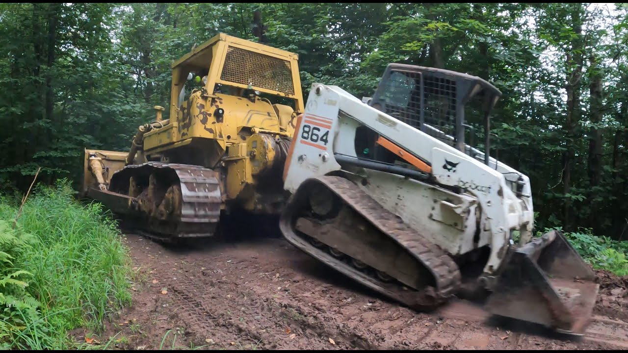 Dragging a broken Bobcat with a dozer
