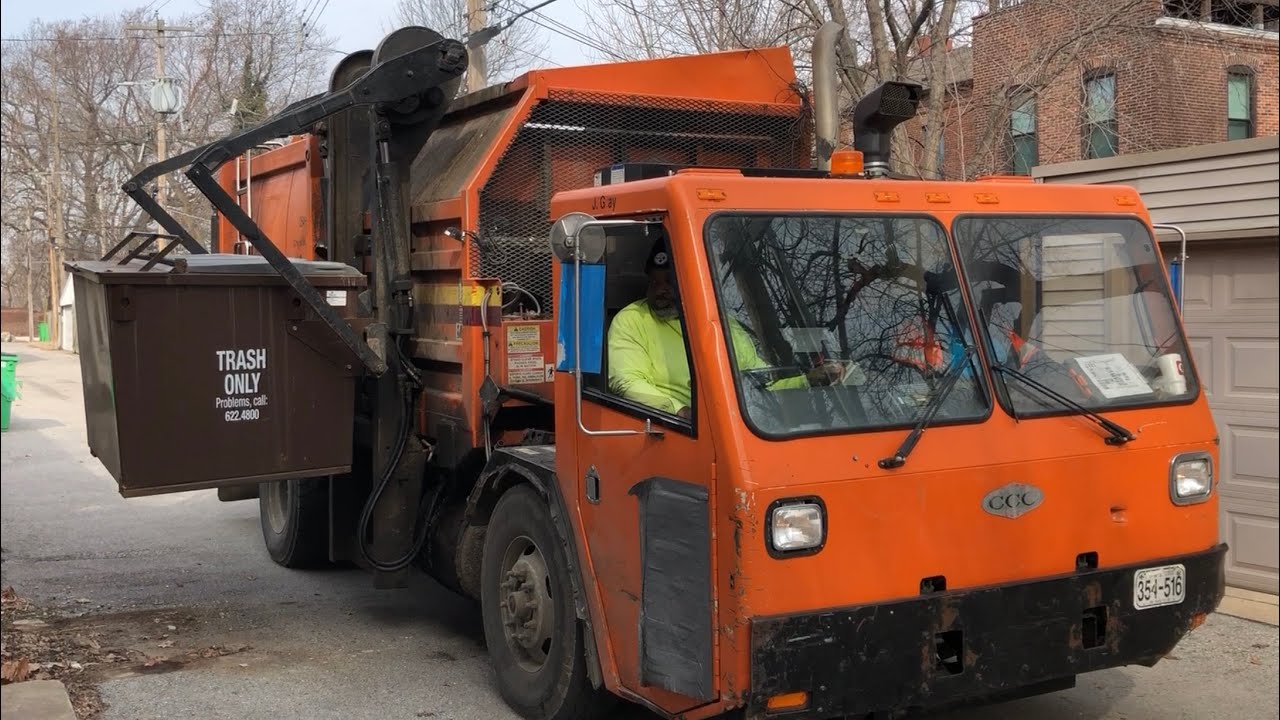 2 Orange Commercial Side Loader Garbage Trucks in St Louis Alleys