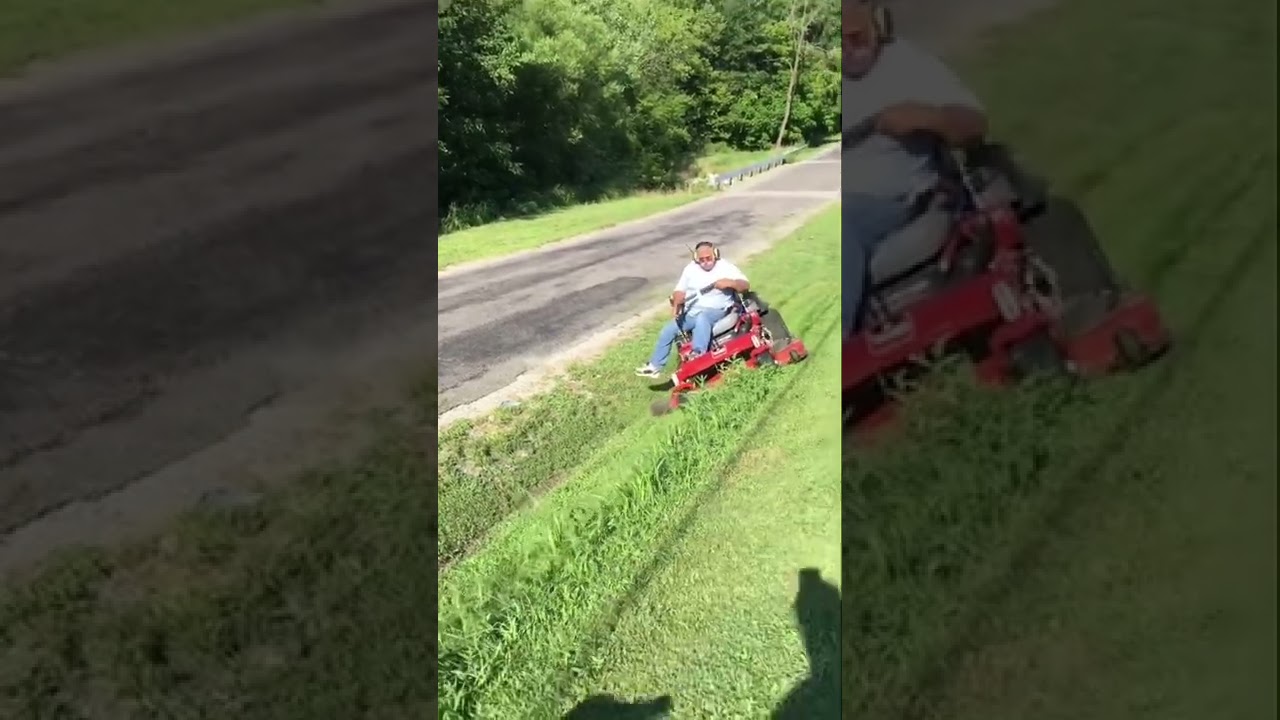 How NOT to mow, trying to hold the mower on the hillside.