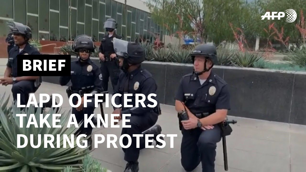 Los Angeles officers take a knee during George Floyd protest | AFP