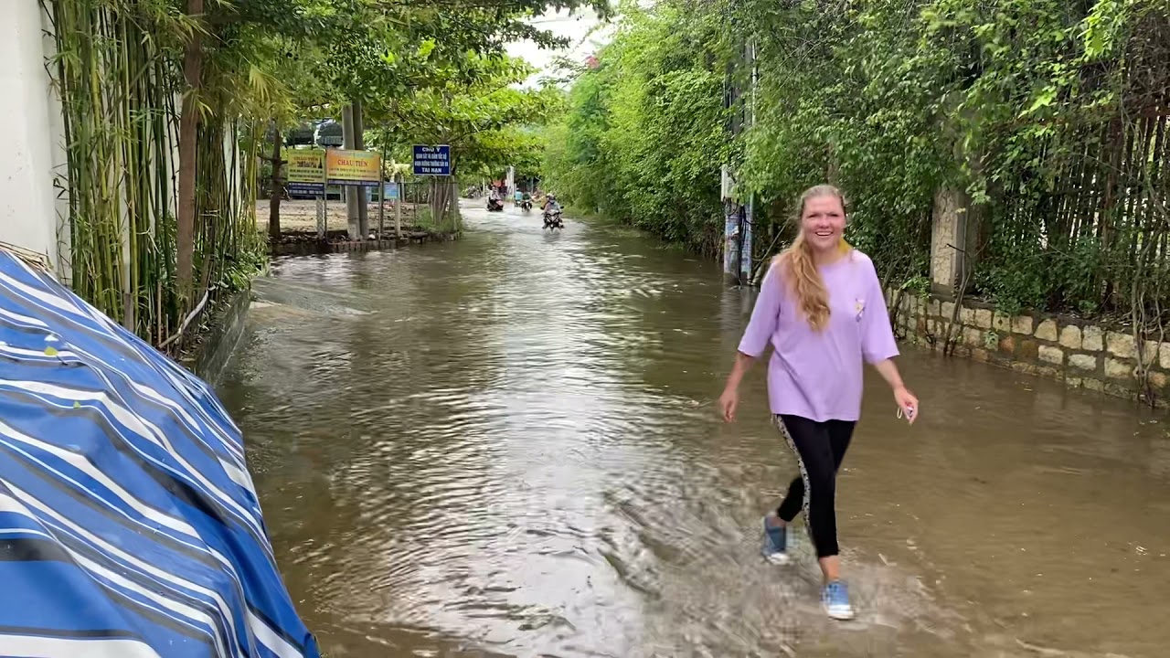 It's a real flood after rain! • Purple shirt, black leggings, sneakers • walking and puddles