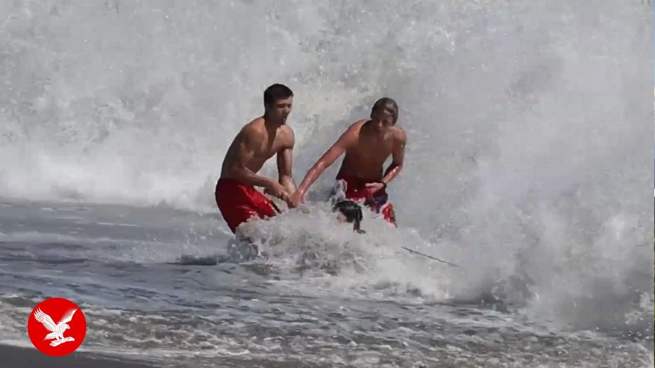 Dramatic rescue sees teen lifeguard battle terrifying waves to save boy dragged out to sea