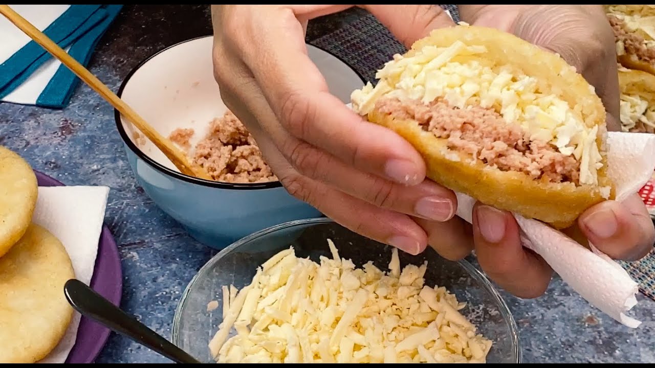 Fried arepas with deviled ham and cheese