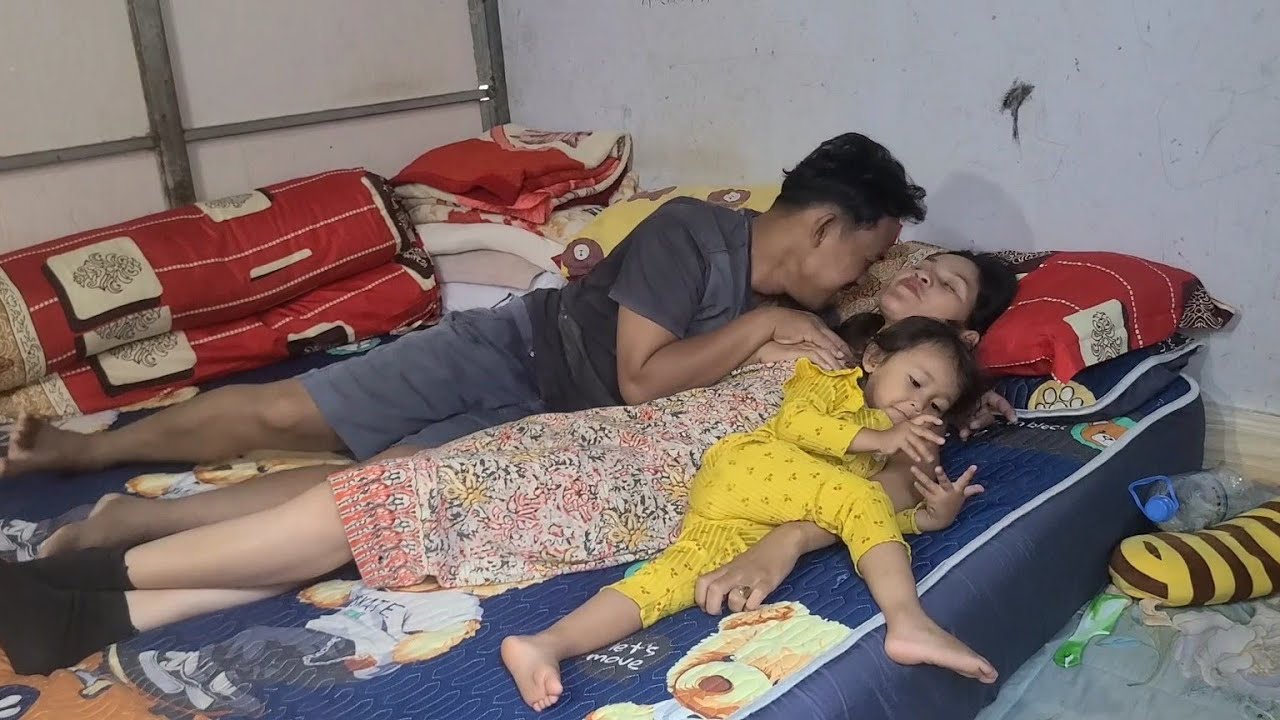 Sweet husband and wife playing with their children in the living room.